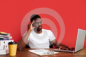 Young sad and depressed african man working in stress at office computer desk feeling overwhelmed