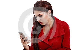 Young sad girl reading text message on her telephone