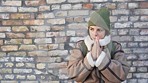 Young sad homeless woman feeling depressed and abandoned standing outdoor on the street. Female with mental illness suffering from