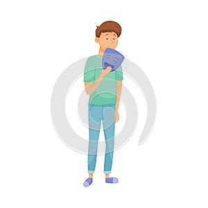 Young Sad Man Standing and Holding Mask with Happy Emotion in His Hands Vector Illustration