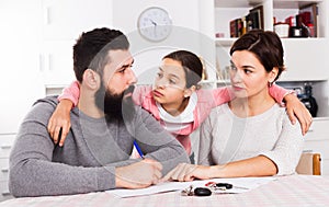 Parents signing papers for divorce