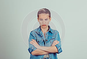 Young sad woman in blue jeans coat isolated on green grey background wall. Negative human emotions, face expressions, body