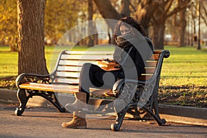 Young sad woman sitting alone