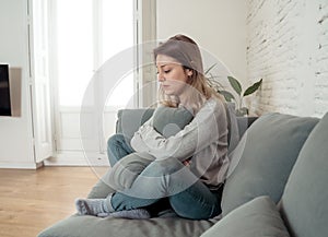 Young sad woman suffering from depression feeling desperate and lonely at home