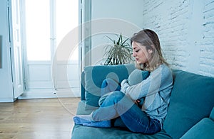 Young sad woman suffering from depression feeling desperate and lonely at home