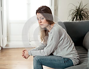 Young sad woman suffering from depression feeling desperate and lonely at home