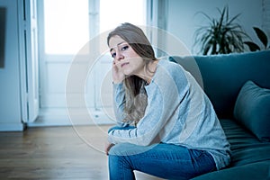 Young sad woman suffering from depression feeling desperate and lonely at home