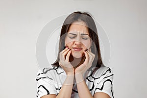 Young sad woman suffering from tooth pain