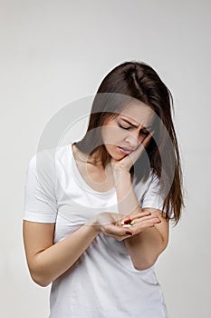 Young sad woman suffering from tooth pain