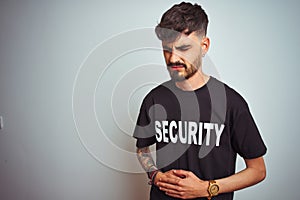 Young safeguard man with tattoo wering security uniform over isolated white background with hand on stomach because nausea,