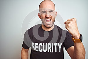 Young safeguard man wearing security uniform over isolated background angry and mad raising fist frustrated and furious while
