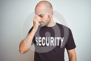 Young safeguard man wearing security uniform over isolated background tired rubbing nose and eyes feeling fatigue and headache