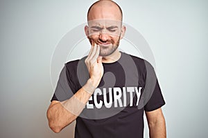 Young safeguard man wearing security uniform over isolated background touching mouth with hand with painful expression because of