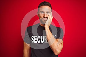 Young safeguard man wearing security uniform over red isolated background thinking looking tired and bored with depression