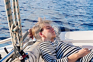 Young sailor dozing while calm