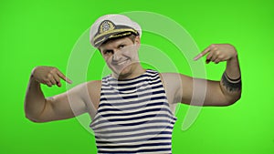 Young sailor man pointing oneself with fingers proud and happy. Seaman guy