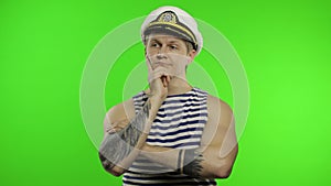 Young sailor man thinks and gets a great idea. Seaman guy in sailor`s vest