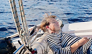 Young sailor resting while calm