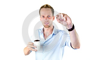 Young salesman holding cup and coffee beans