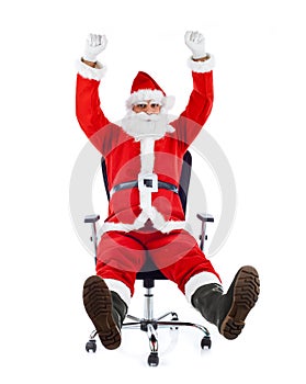 Young Santa Claus sitting on an office chair.