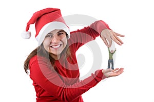 Young santa woman holding small funny person