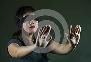 Young scared and blindfolded Asian Chinese teenager girl lost and confused playing dangerous internet viral challenge on