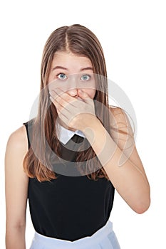 Young scared teenage girl covering her mouth with hand isolated