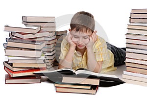 Young school boy reading books