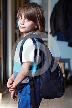 Young schoolboy with his backpack