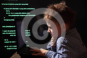 Young schoolboy prodigy - a hacker. Gifted student enters into the banking system. photo