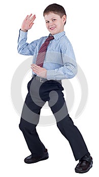 Young schoolboy in school uniform showing karate