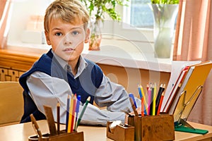Young schoolboy sitting Behind a school desk