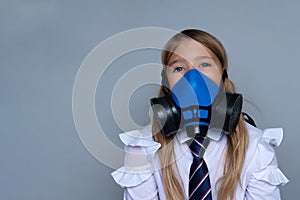 Young schoolchild in gasmask closeup portrait