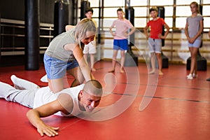 Young schoolgirl practicing basic self-defense moves
