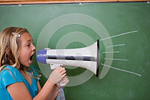 Young schoolgirl screaming through a megaphone