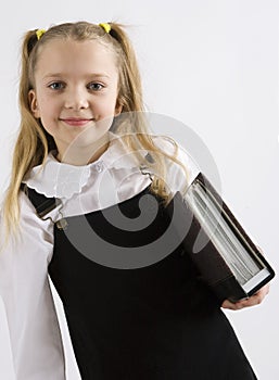 Young schoolgirl writing in a classroom