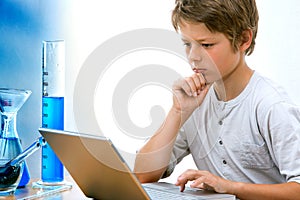 Young science student with laptop.