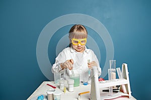 Young scientist child making experiments in his home laboratory. Science child girl