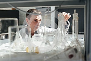 Young scientist conducts chemical experiments in the laboratory photo