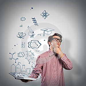 Young scientist holding a book