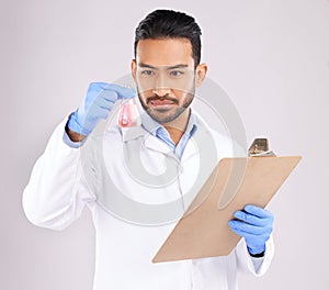Young scientist man, beaker and checklist with thinking, analysis and notes in studio by white background. Asian science