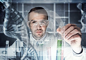 Young scientist mixing reagents in glass flask in clinical laboratory