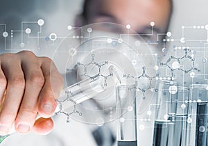 Young scientist mixing reagents in glass flask in clinical laboratory