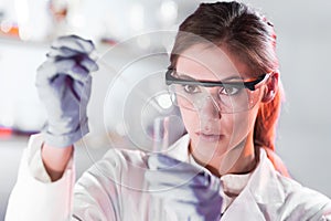 Young scientist pipetting in life science laboratory.