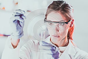 Young scientist pipetting in life science laboratory.