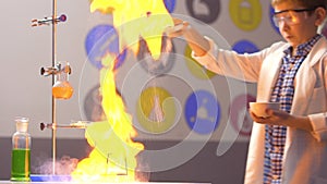 Young scientist strews starch on fire in laboratory