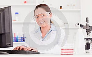 Young scientist typing a report