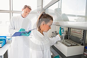 Young scientist using a pipette in chamber