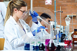 Young scientists carrying out an experiment in a laboratory.