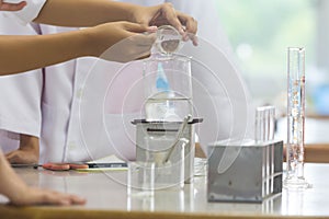 Young scientists are doing experiments in science labs. photo